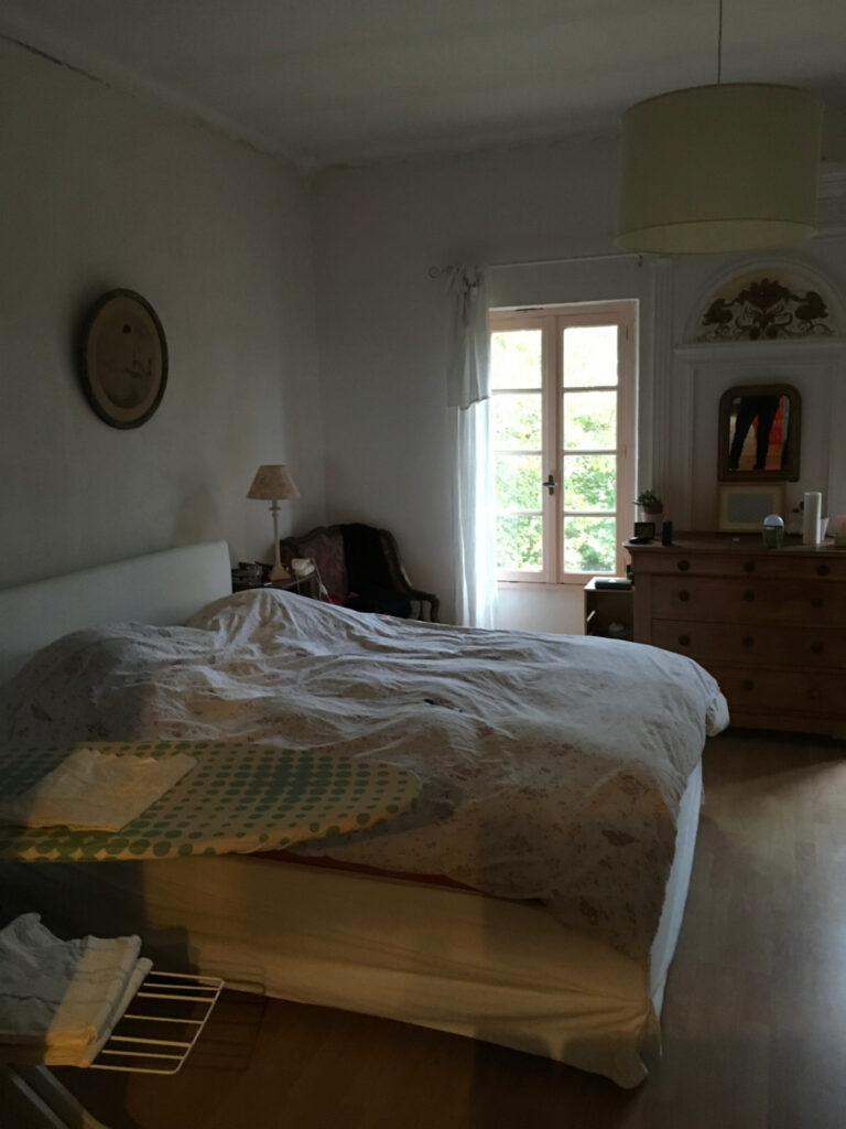 Chambre avec lit et rangement, idéale pour travaux de rénovation énergétique à Toulouse.